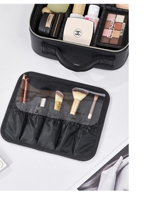 Internal view of travel makeup case with adjustable dividers and brush organizer
