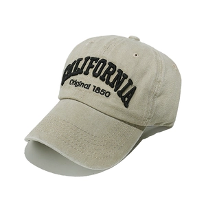 Close-up of black CALIFORNIA 1850 embroidery on beige cotton twill baseball cap