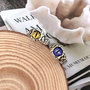 Detail of vintage punk adjustable rings with yellow and purple evil eye gemstones