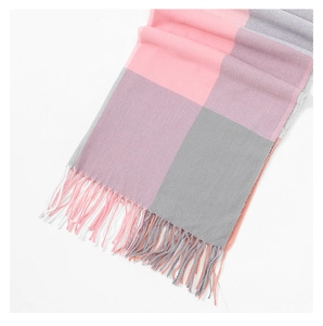 Detail of soft plaid scarf with pink grey and purple blocks and fringe trim