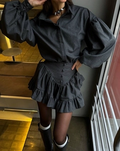 Detail of grey two-piece set featuring puff sleeves and high-waisted ruffled skirt
