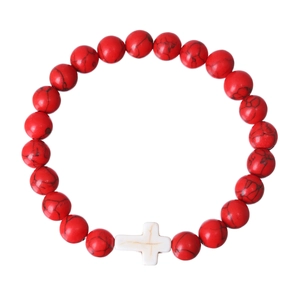 Detailed close-up of a red stone beaded bracelet featuring a white cross charm centerpiece