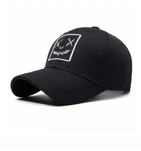 Detail of black cotton baseball cap featuring white square embroidery with X-shaped eyes