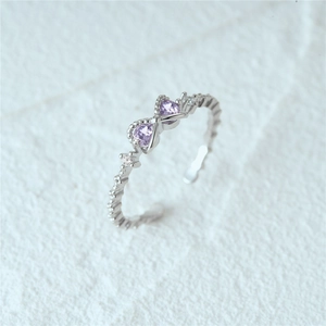 Close-up of S925 silver ring featuring purple heart-shaped stones and bead texture