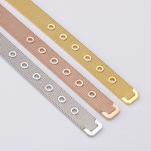 Macro detail of adjustable mesh watch strap in gold, rose gold and silver stainless steel