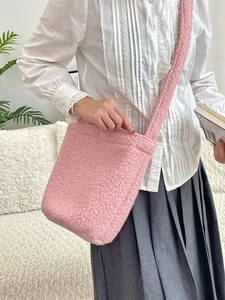 Pink plush crossbody bucket bag made of soft teddy fleece with a spacious interior for women