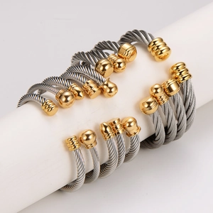Two-tone stainless steel cable wire bracelet with silver rope and gold ball ends