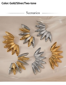 Macro shot of hip hop leaf earrings in gold, silver and two-tone polished finishes
