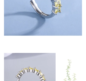 Close-up of a silver ring featuring a vibrant yellow square-cut zircon gemstone setting