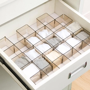 Brown translucent modular drawer dividers for organized sock storage in a white drawer