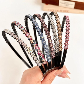Detail showing various colors of rhinestone flower headbands with non-slip teeth grip