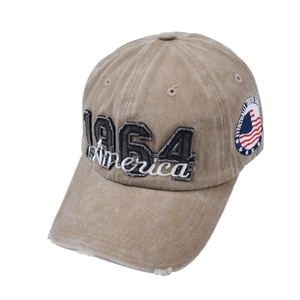 Detailed embroidery of 1964 America patch on distressed khaki cotton baseball cap