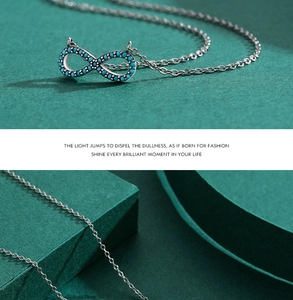 Detailed close-up of S925 sterling silver infinity pendant with turquoise gemstones