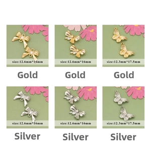 Detailed macro view of 18k gold plated bow and butterfly pendants with zircon for DIY jewelry