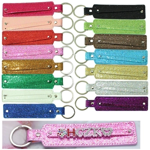 Close-up of sparkling 8mm glitter keychain straps with custom rhinestone letters