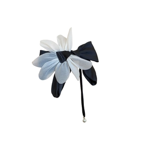 Elegant black satin ribbon bow with a white sheer fabric flower and pearl charm