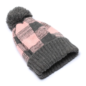 Close-up of pink and grey checkered knit beanie with a fluffy faux fur pompom decoration