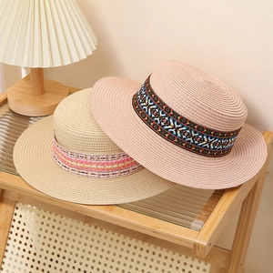 Flat top straw sun hats in beige and pink with bohemian ethnic style patterned bands