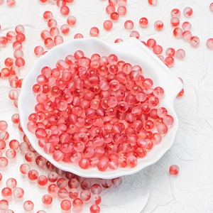 Frosted red pink translucent 6mm 8mm glass beads in a white shell dish for DIY jewelry