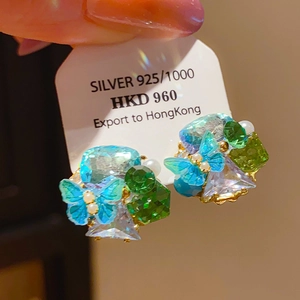 Detail of 925 silver butterfly earrings with blue and green teardrop crystals and pearls