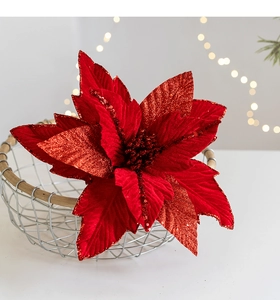 Close-up of red glitter poinsettia flower in wire basket with festive bokeh lighting