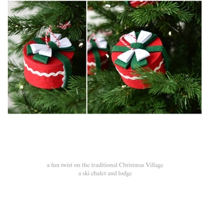 Close-up of red felt Christmas gift box ornament hanging on a festive tree branch