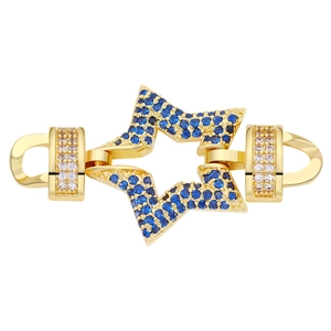 Macro view of gold star connector with blue cubic zirconia and white gems for jewelry