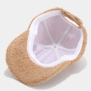 Detailed interior view of the brown fuzzy lamb wool cap showing clean stitching and lining
