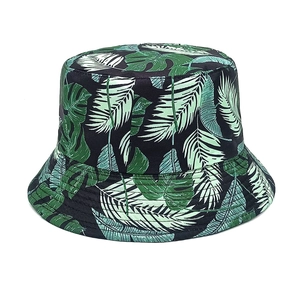 Detailed view of tropical plant print and reinforced stitching on dark bucket hat