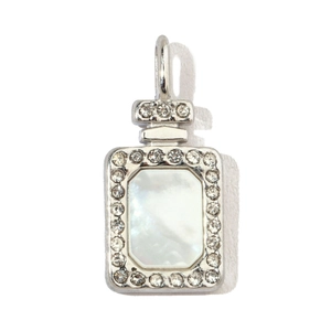 Macro detail of silver perfume bottle pendant with mother of pearl and crystal inlay