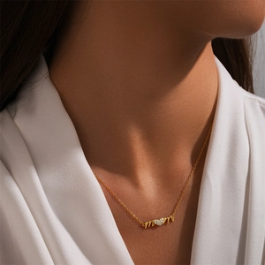 Macro view of gold S925 sterling silver Mom heart pendant necklace worn by a model