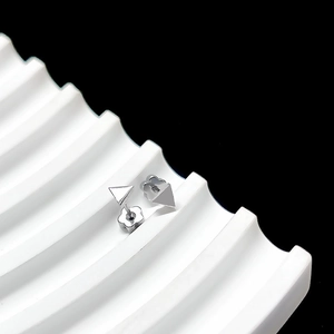 Detailed view of silver triangular stud earrings with petal-shaped backs on white wavy stand