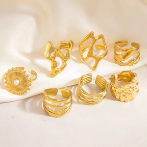 Set of seven vintage 18K gold plated stainless steel irregular rings on silk fabric