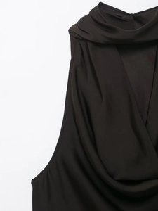 Close-up of black satin top featuring fringe details and elegant draped cowl neckline