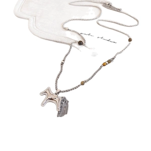Vintage silver long necklace featuring a horse pendant with tassels and brown beads
