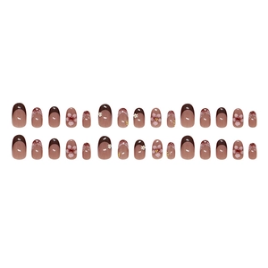 French press-on nails with brown tips and 3D floral accents in oval shape