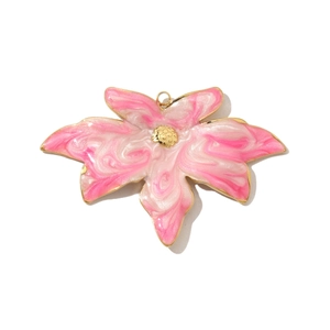 Detailed macro of a flower pendant with pink marble enamel and golden metal edging