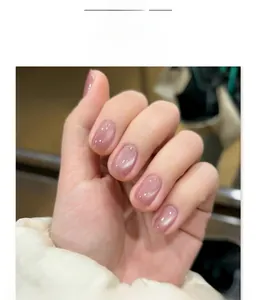 Short square light purple cat-eye press-on nails shown on a hand with white fuzzy sleeve