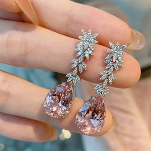 Elegant long teardrop earrings with pink pear-shaped gemstone and crystal leaf design