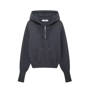 Detail of dark grey knit hoodie featuring half-zipper closure and drawstring hood texture