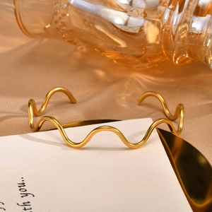 Minimalist golden wavy open cuff bracelet with a polished finish for women