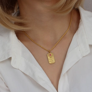 Gold tarot lovers necklace with red zircon and embossed rose pendant on a model