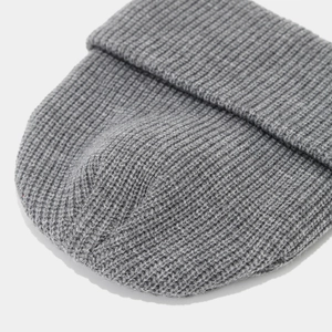 Close-up of gray ribbed knit beanie showing high-quality texture and folded cuff detail