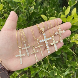 Close-up of six gold 18K plated cross pendants with micro-pave cubic zirconia crystals