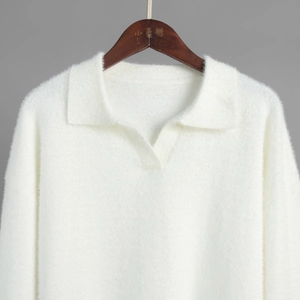 Detailed view of white knitted polo neck sweater with soft faux mink fur texture