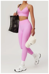Close-up of pink high-waisted seamless yoga leggings and strappy sports bra set