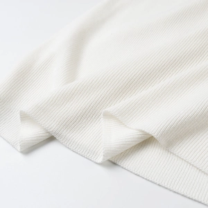 Close-up of premium white ribbed knit fabric texture showing material softness and elasticity