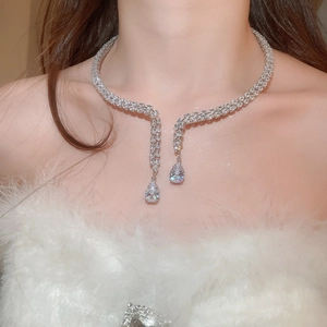 Detail view of silver luxury choker with sparkling teardrop zircons on a neck