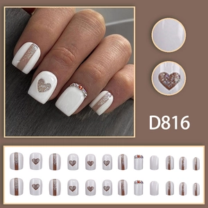 Chic pearl white press-on nails set with glitter heart patterns and crystal rhinestone accents