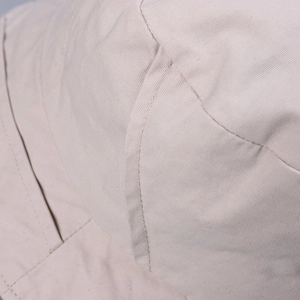 Detail of reinforced double stitching on high-quality beige washed cotton sun hat fabric